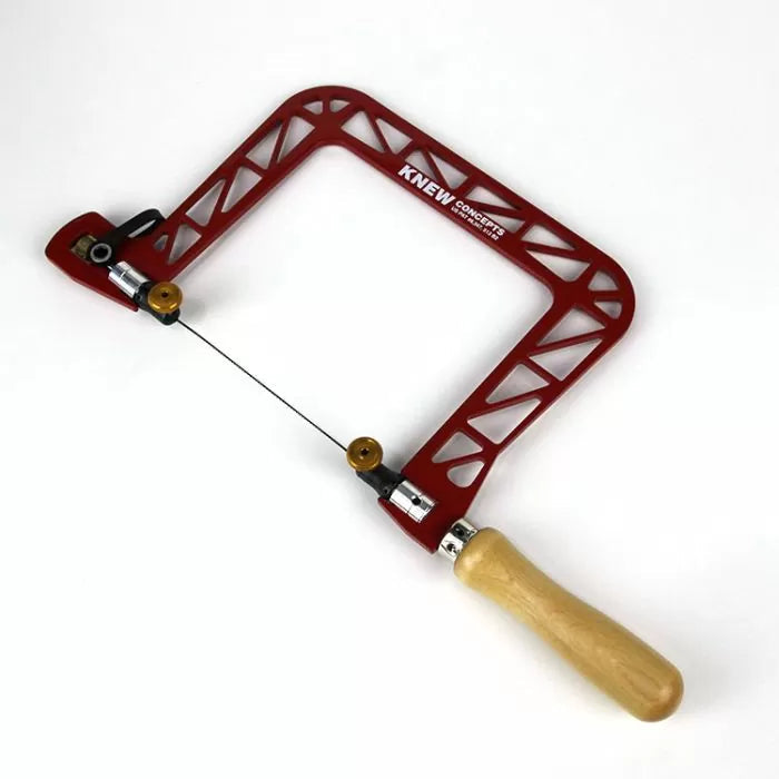 Red aluminum coping saw with wood handle and fine blade for precision woodworking cuts