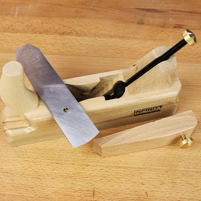 Wooden hand plane with steel blade and adjustment knob on a woodworking bench