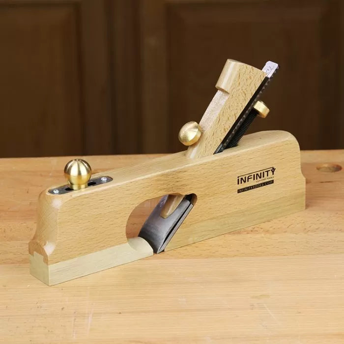 Wooden hand plane with brass knobs on a workbench for woodworking joinery