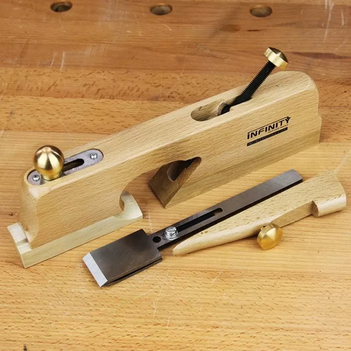 Wooden shoulder plane hand tool with brass fittings on a workbench, ideal for woodworking