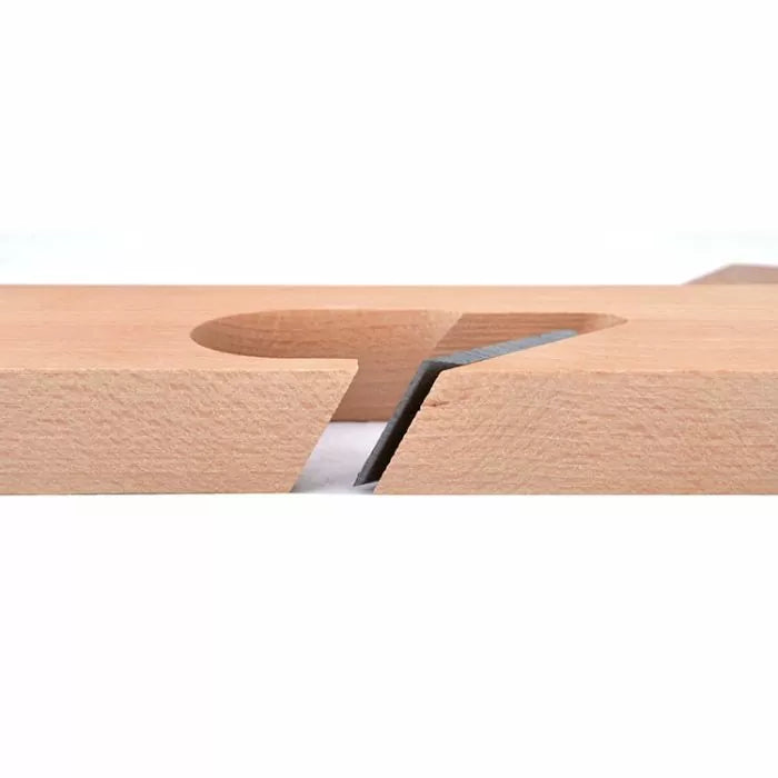 Closeup of a precisely angled dado cut in light wood, showing clean woodworking joinery.