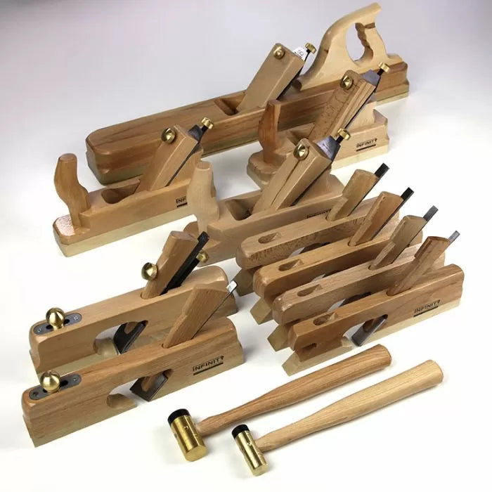 Woodworking hand plane set and mallets with brass and wood handles on white background