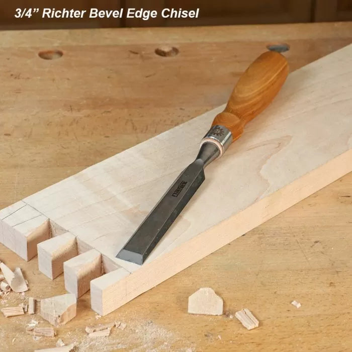3/4 inch bevel edge chisel with wooden handle on workbench and dovetail wood joint