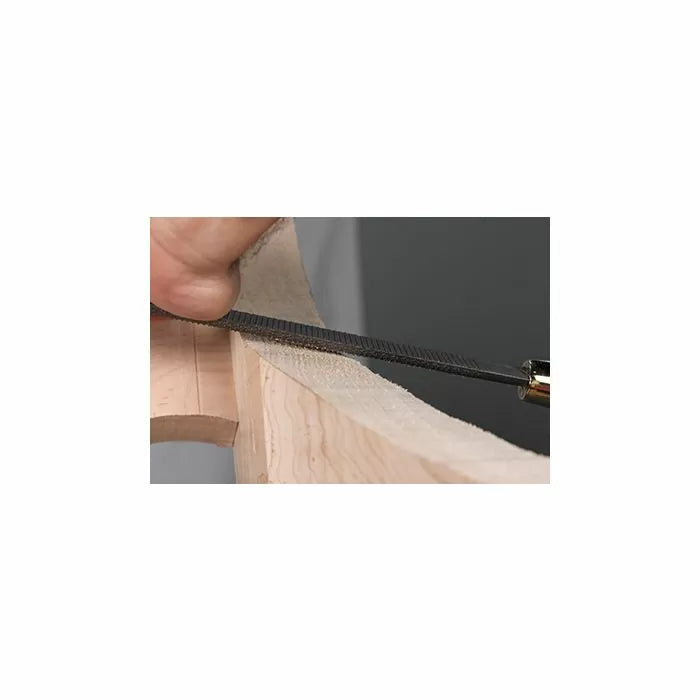 Hand using a woodworking rasp to shape a curved wooden edge