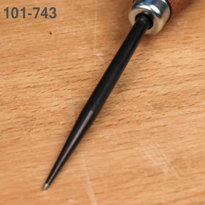 Woodworking center punch tool with pointed steel tip on a wooden workbench