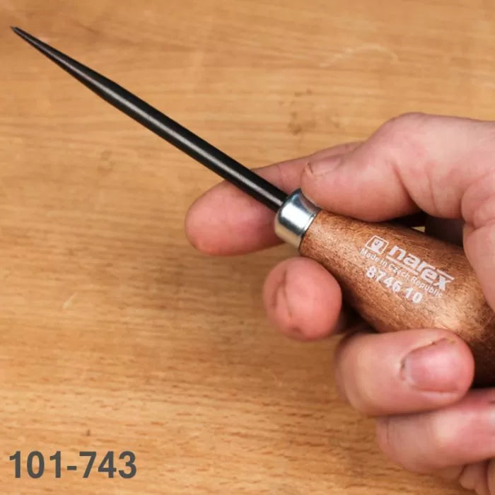 Woodworking scratch awl with wooden handle held in hand on workbench