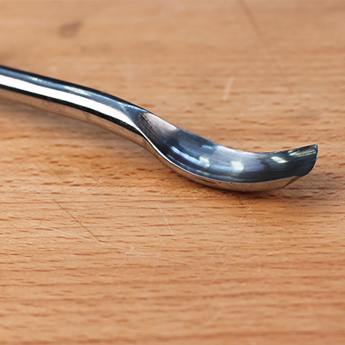 Curved carving gouge chisel on a wooden workbench for woodworking projects