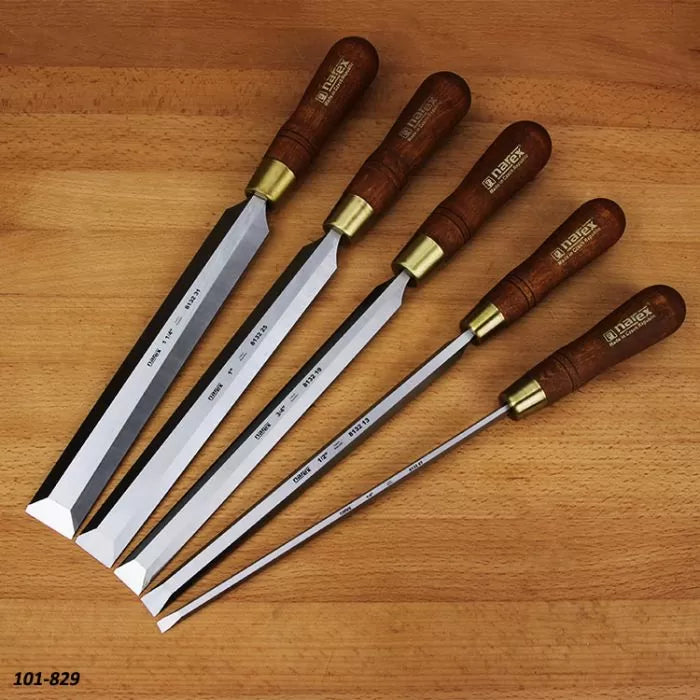 Set of five woodworking chisels with wooden handles on a wood surface