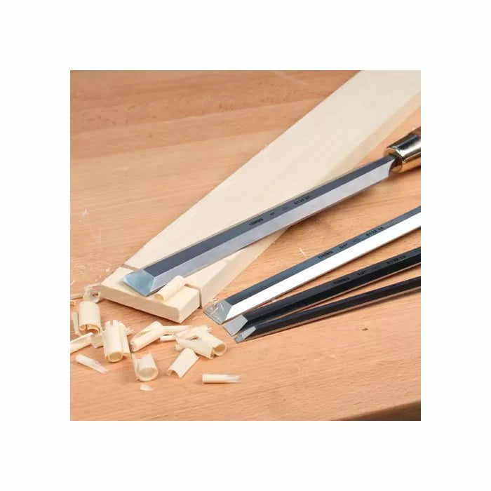 Woodworking chisels shaving wood strips on a workbench, precision hand tools for carpentry