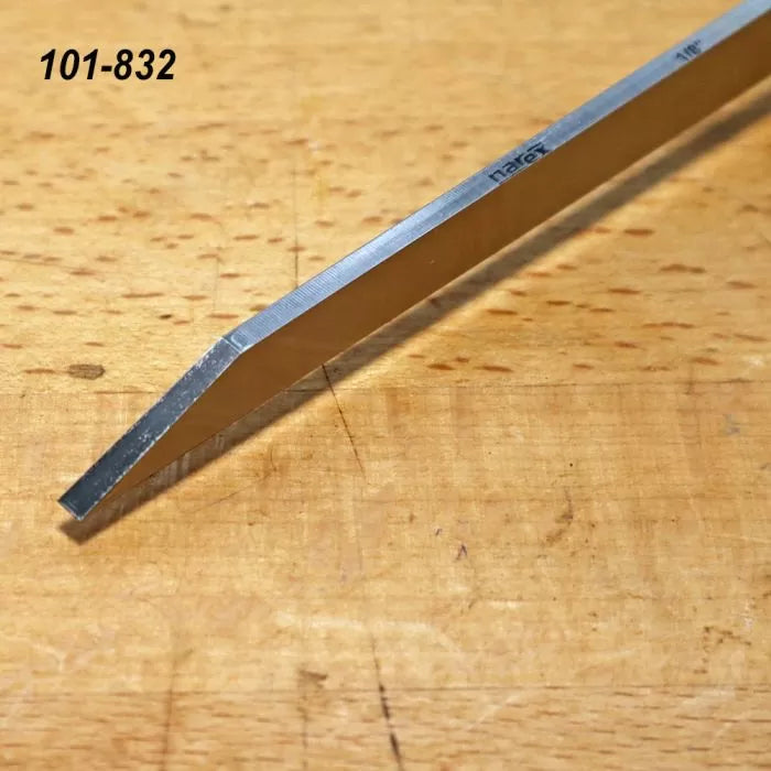 Steel woodworking chisel with beveled edge on a wooden workbench, labeled 101-832.