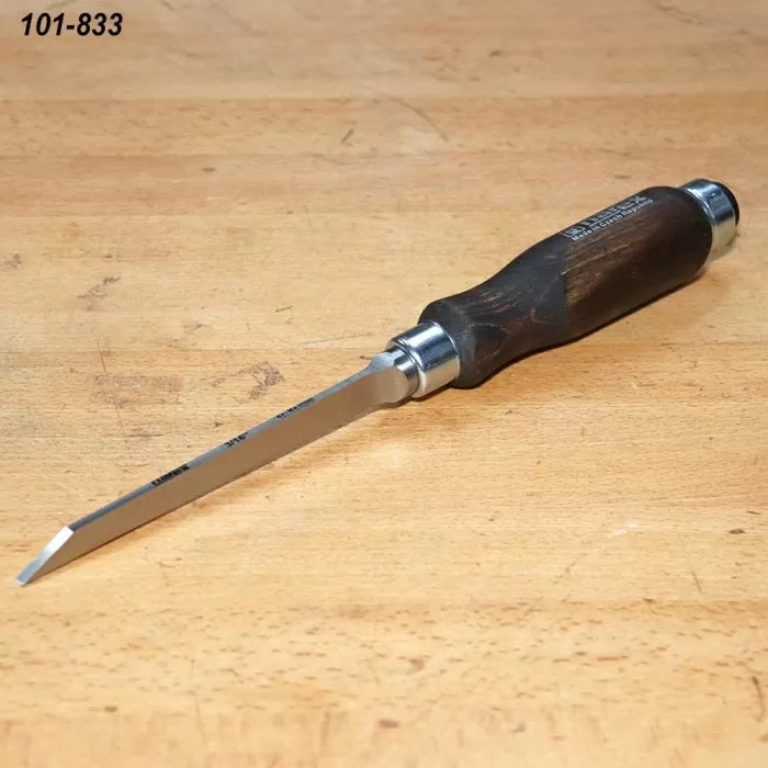 Bench chisel with beveled blade and wooden handle on a woodworking table