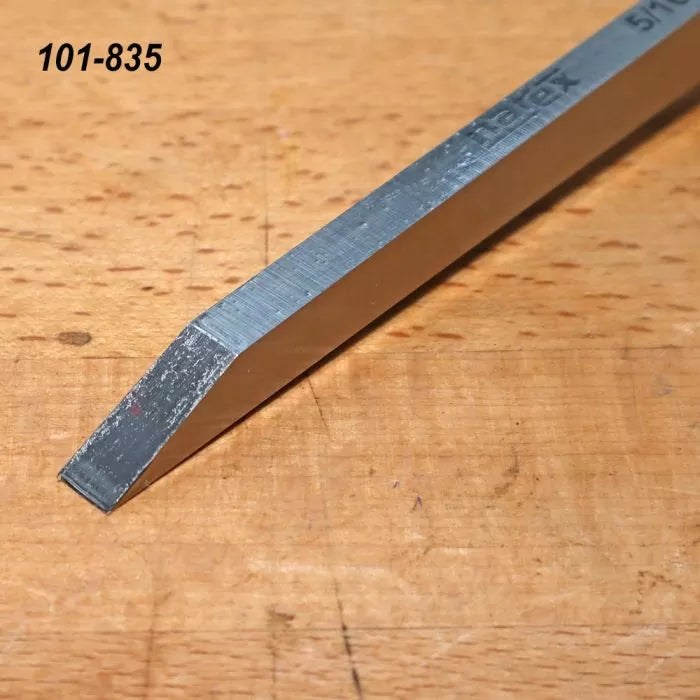 High-speed steel lathe tool blank with beveled end on a wooden workbench