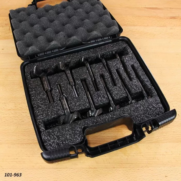 Router bit set in foam-lined carrying case on wooden workbench
