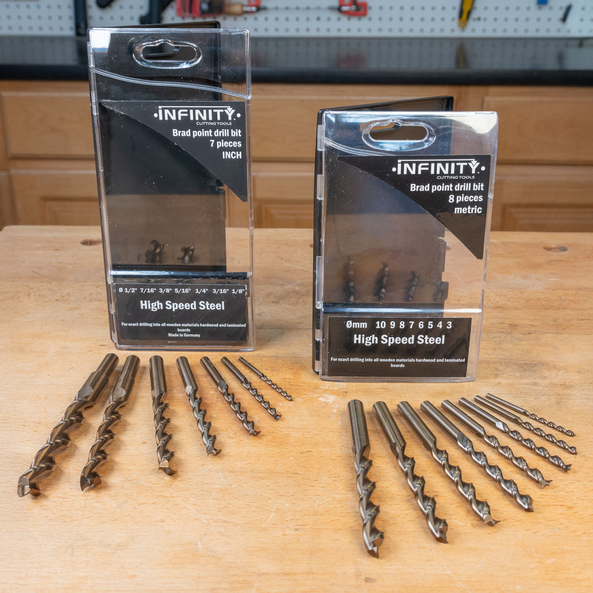 High speed steel brad point drill bit sets in inch and metric sizes on workbench
