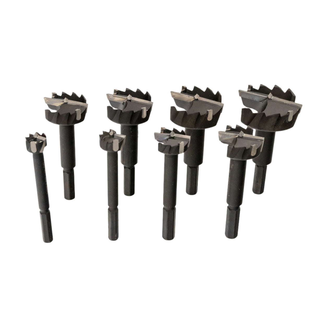 Set of carbide tipped Forstner drill bits for woodworking, various sizes, on white background