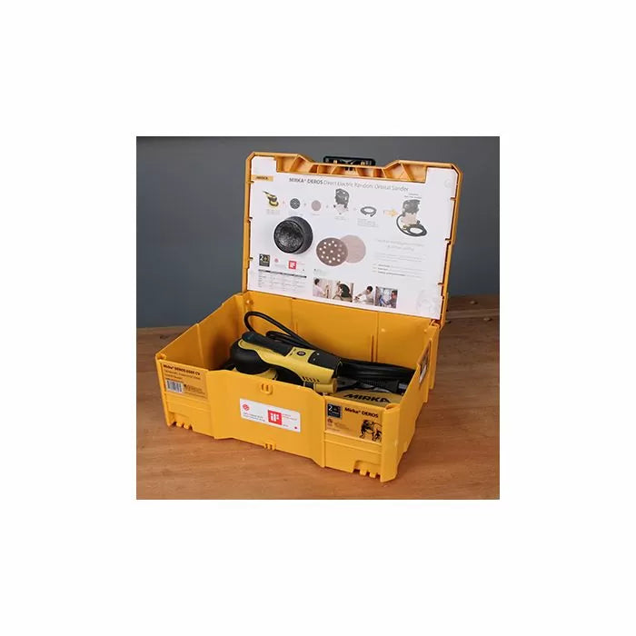 Electric orbital sander in yellow storage case on wood workbench, woodworking tool kit