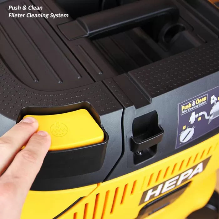 Hand pressing yellow button on HEPA vacuum with push and clean filter cleaning system