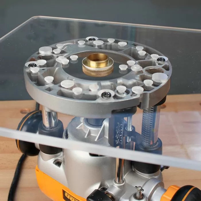 Close-up of a woodworking router base plate with brass guide bushing on a workbench