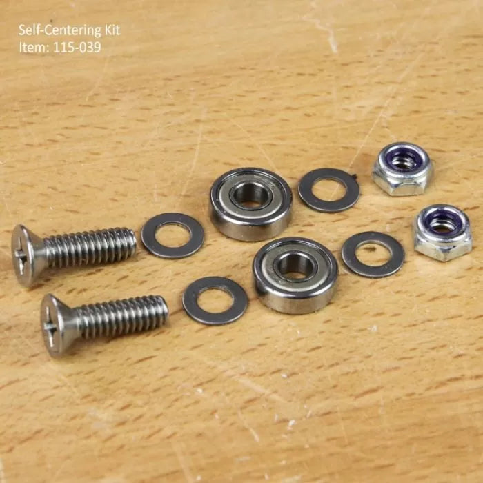 Self-centering kit with screws, bearings, washers, and nuts on a wood surface