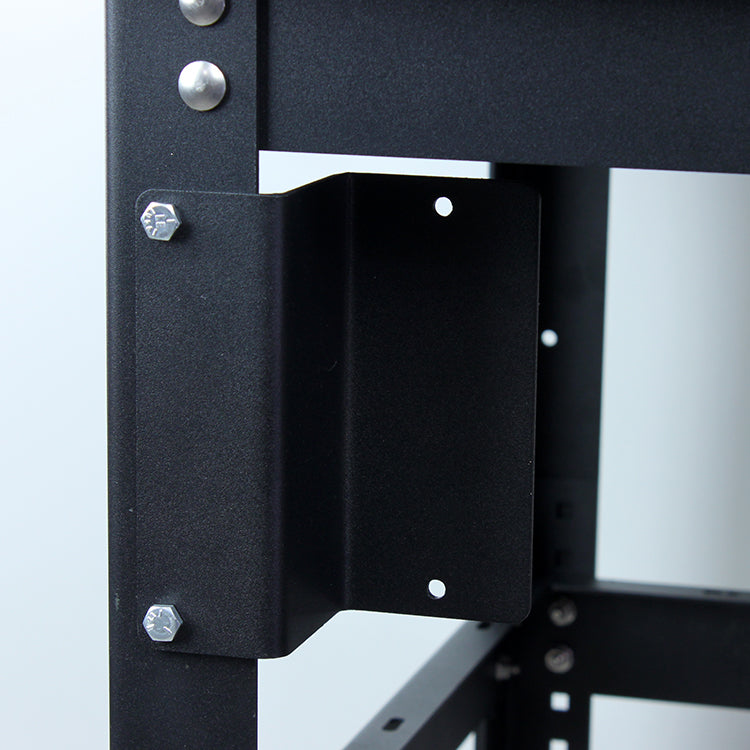 Close-up of black metal bracket with bolts on a woodworking tool stand frame