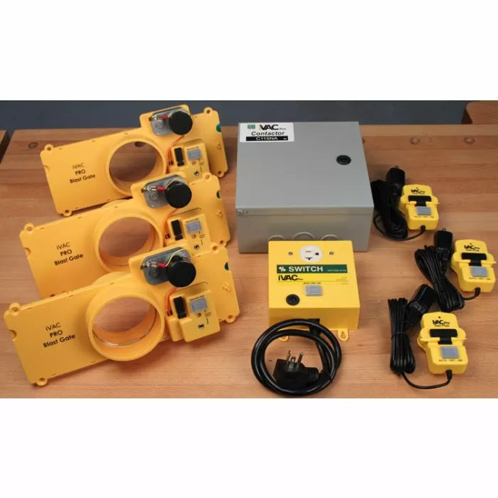 Woodworking dust collection system kit with iVAC blast gates, controller, and switches on workbench