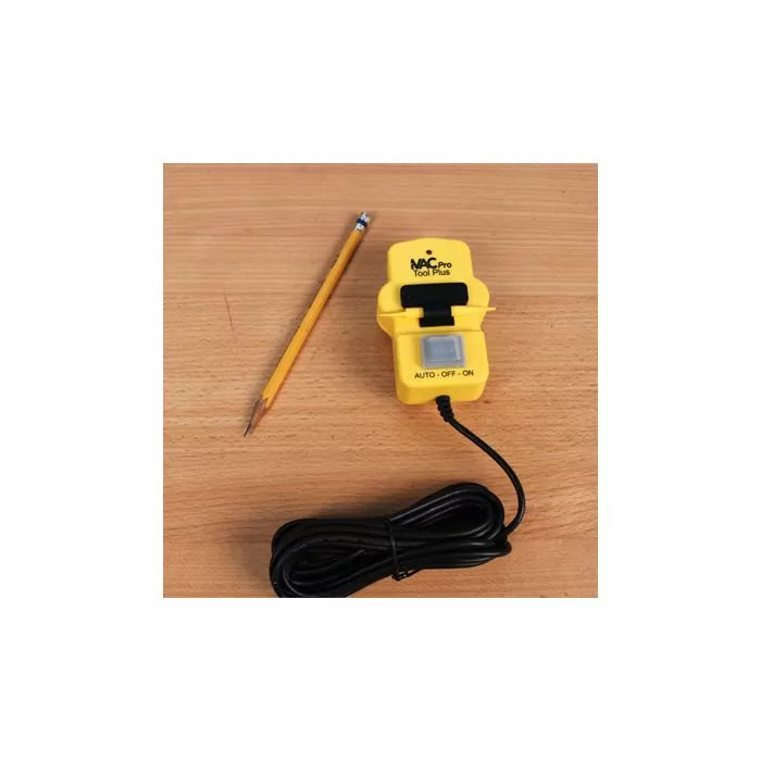 Yellow vacuum tool switch with cord and pencil on wooden surface, woodworking accessory