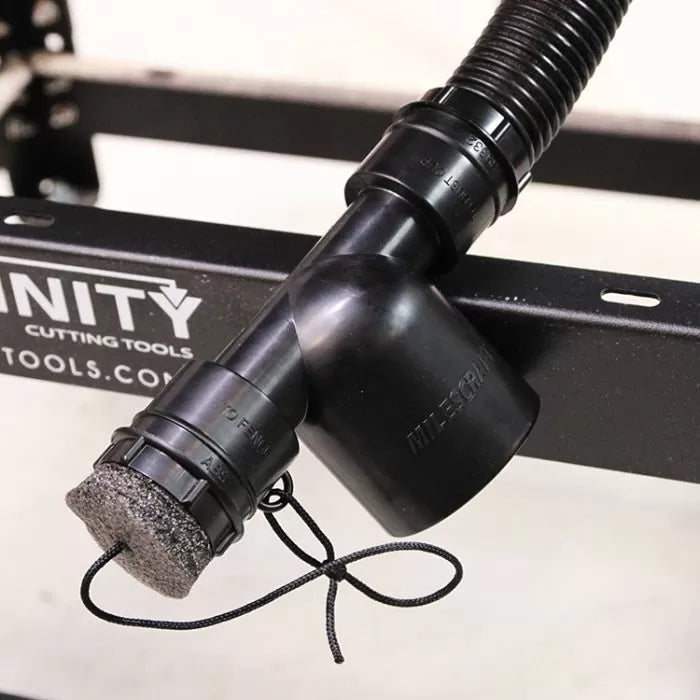 Dust collection hose adapter for woodworking tools attached to a metal table frame