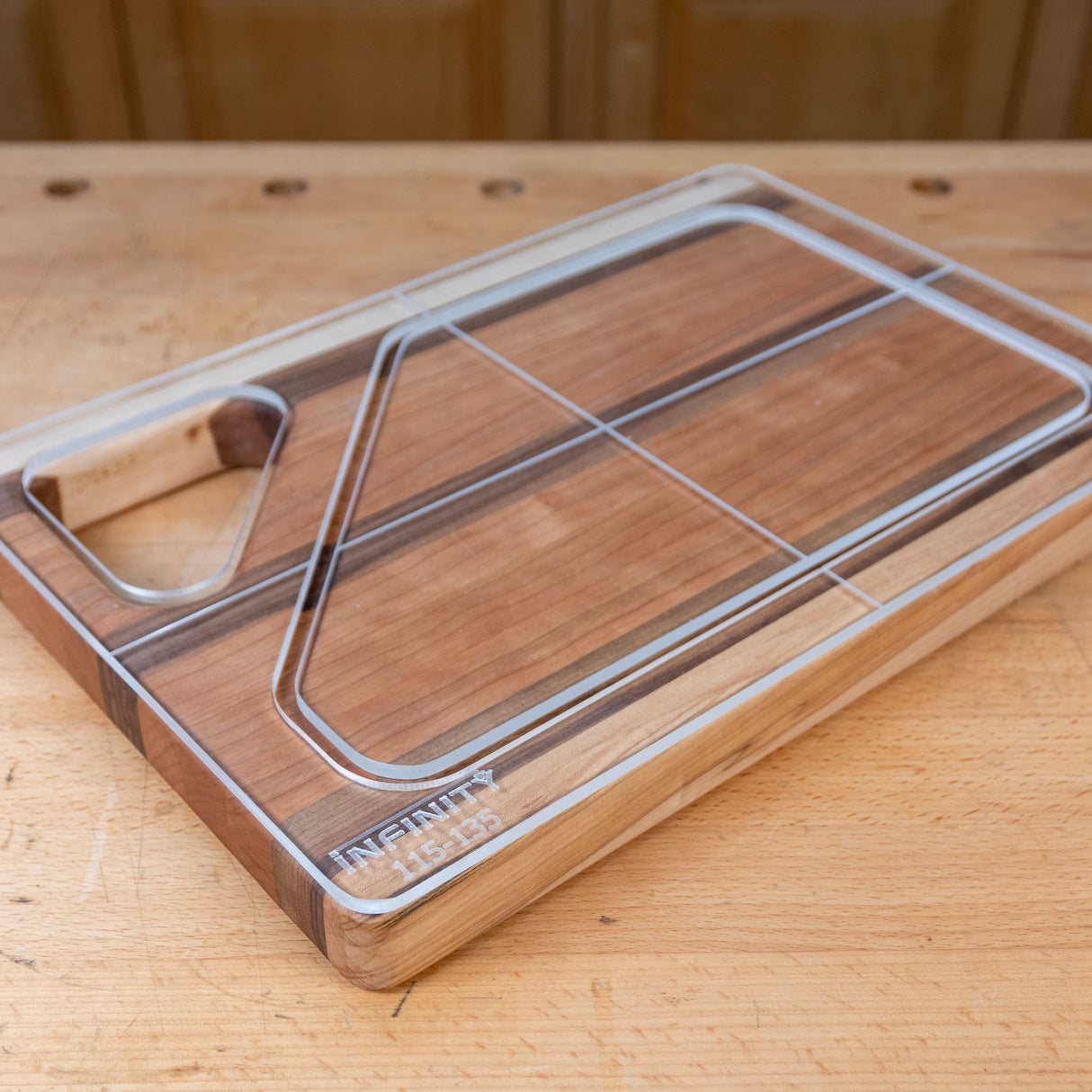 Acrylic cutting board template overlay on wood board, workshop background