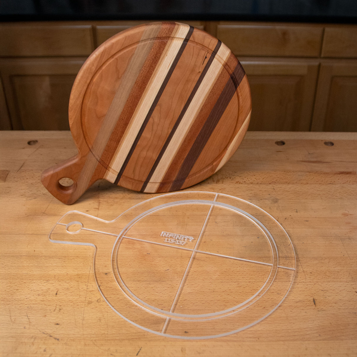 Clear acrylic cutting board template and striped wooden cutting board on a workbench