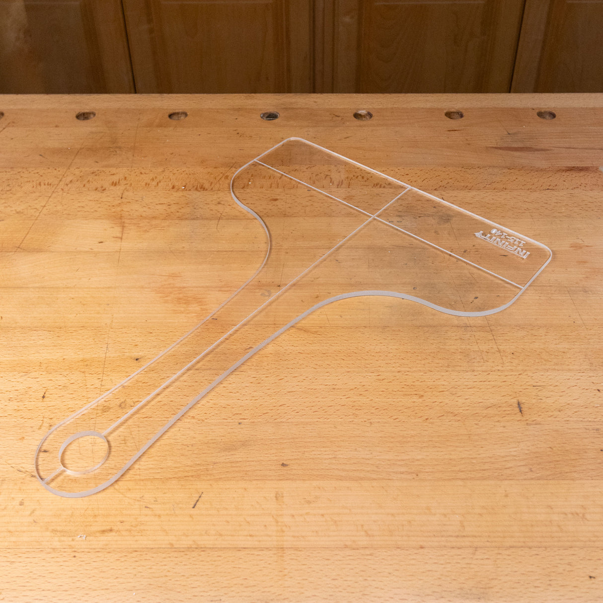 Clear acrylic cutting board template on wooden workbench for woodworking projects