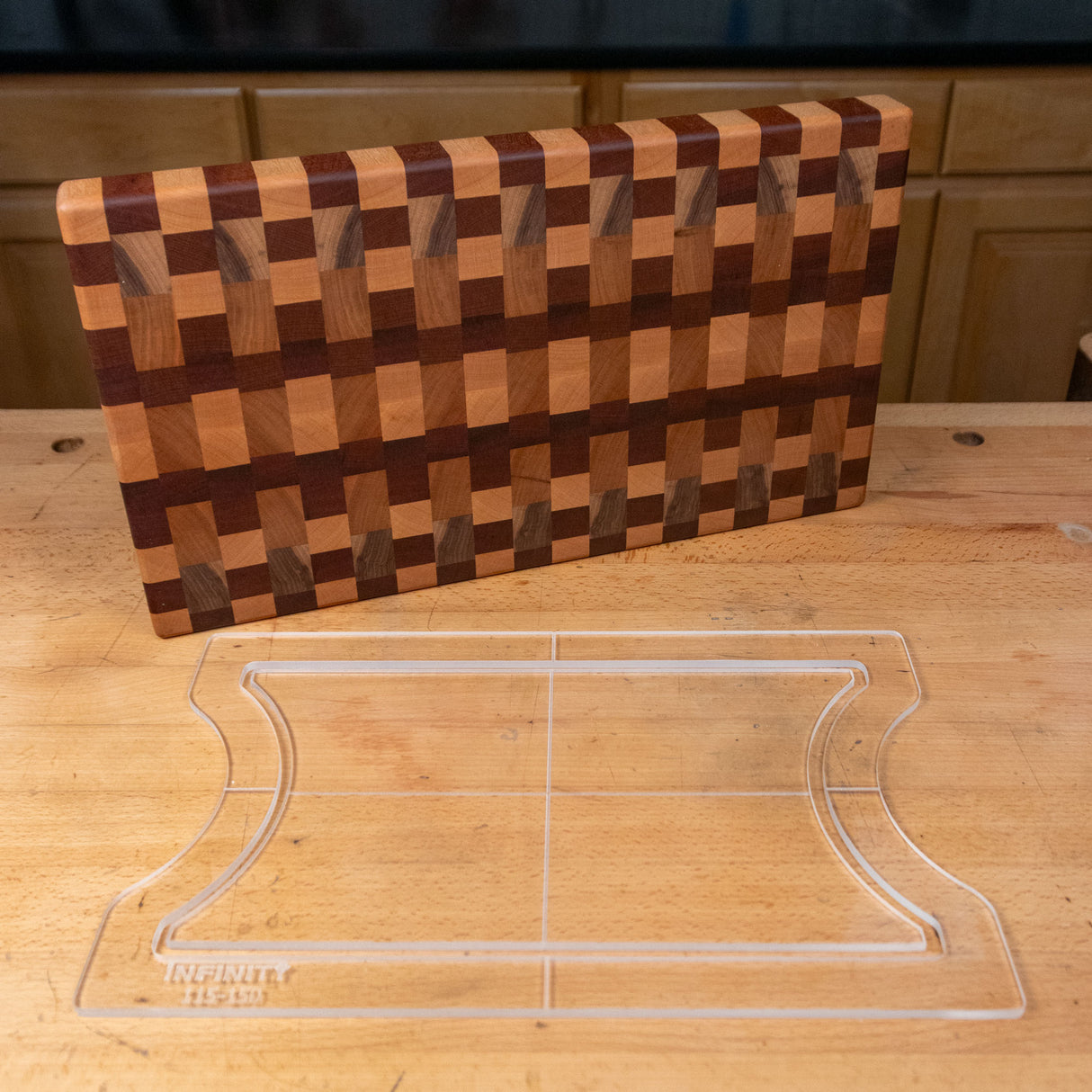 Acrylic cutting board template and wooden end grain cutting board on a workbench