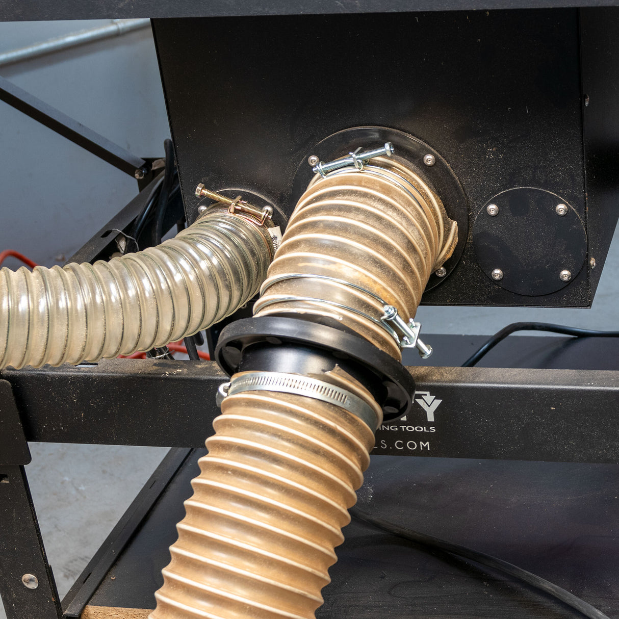 Dust collection hoses connected to a woodworking machine using MagSnap fittings