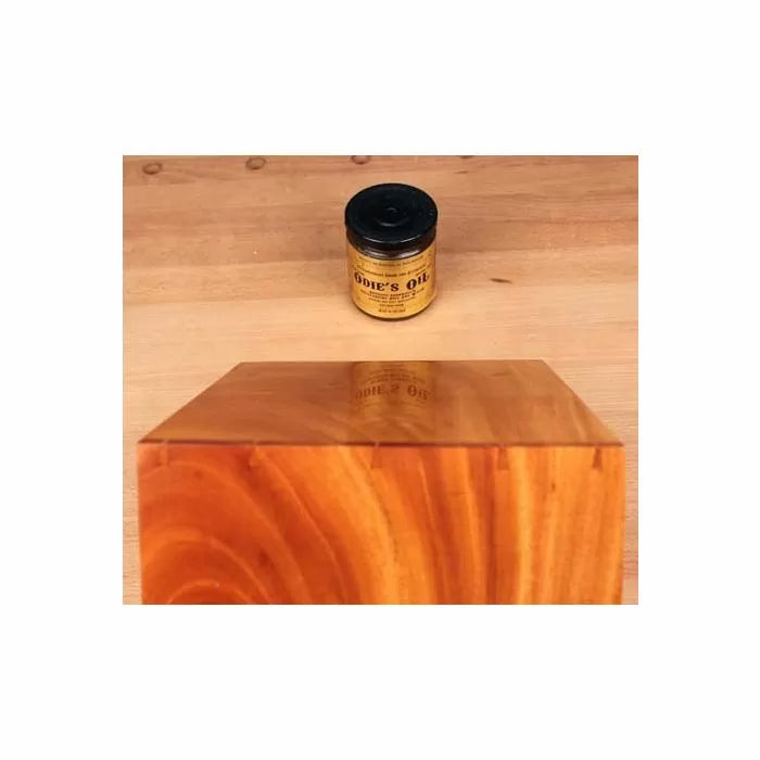 Wood finish jar and polished wooden block on workbench, woodworking tools and supplies