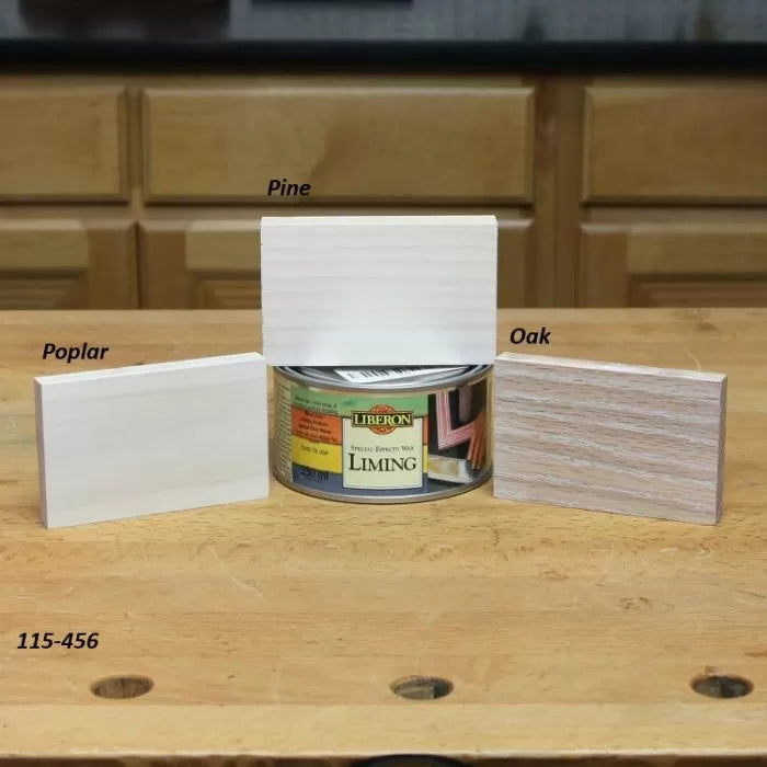 Liming wax can with labeled poplar, pine, and oak wood samples on a workbench