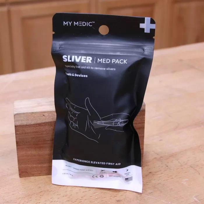Sliver med pack first aid kit for sliver removal on wooden workbench