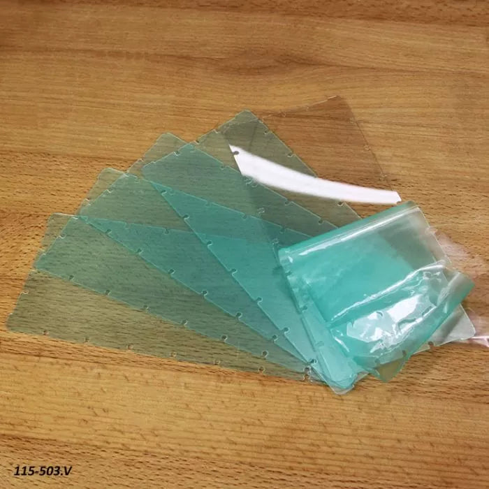 Clear plastic router table insert plates with protective film on a wooden surface
