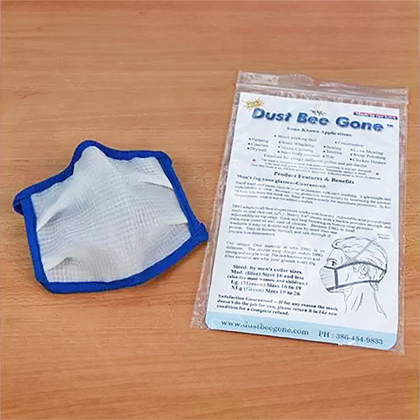 Dust Bee Gone dust mask and packaging on a wooden surface, reusable woodworking respirator