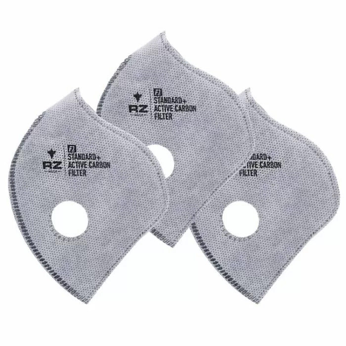 Three gray standard active carbon replacement filters for dust masks, close up on white background