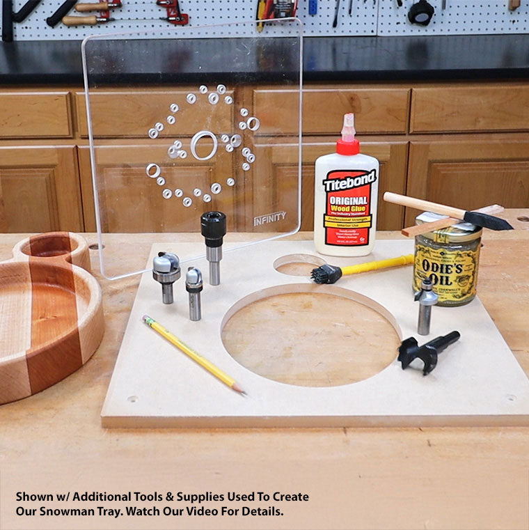 Woodworking tray template kit with router bits, wood glue, oil, and tools on a workshop bench.