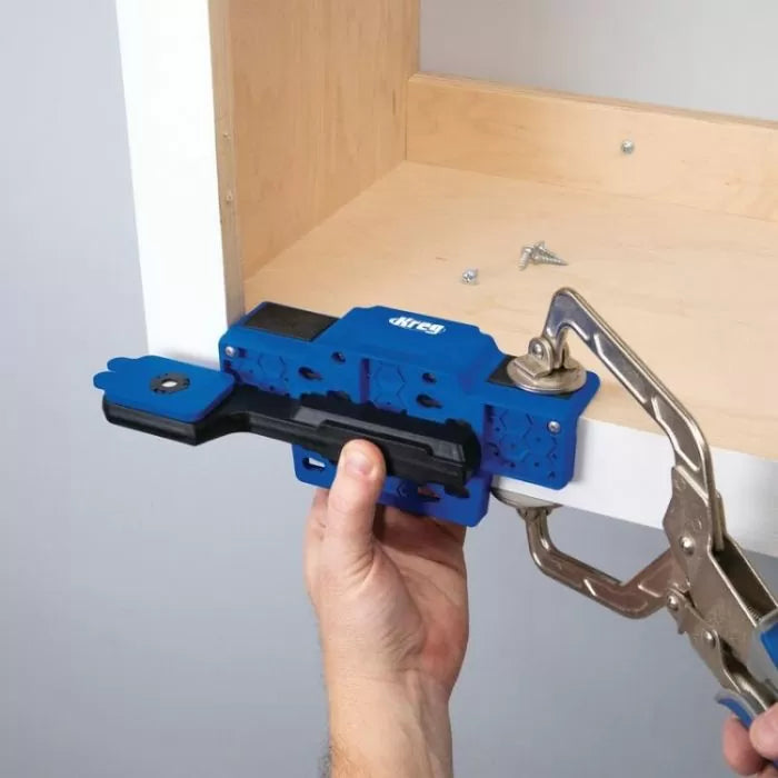 Cabinet hardware installation jig clamped to a drawer face for accurate handle placement