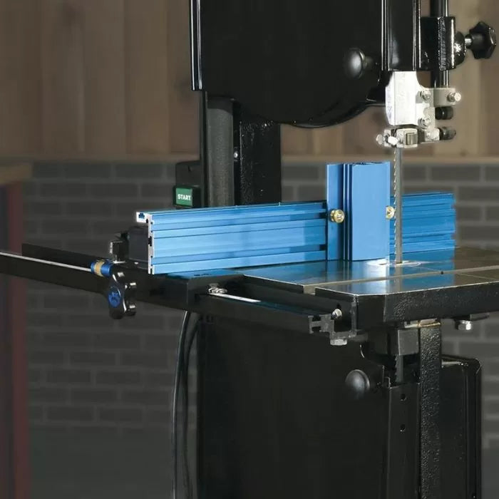 Band saw with blue aluminum fence system for precise woodworking cuts in workshop