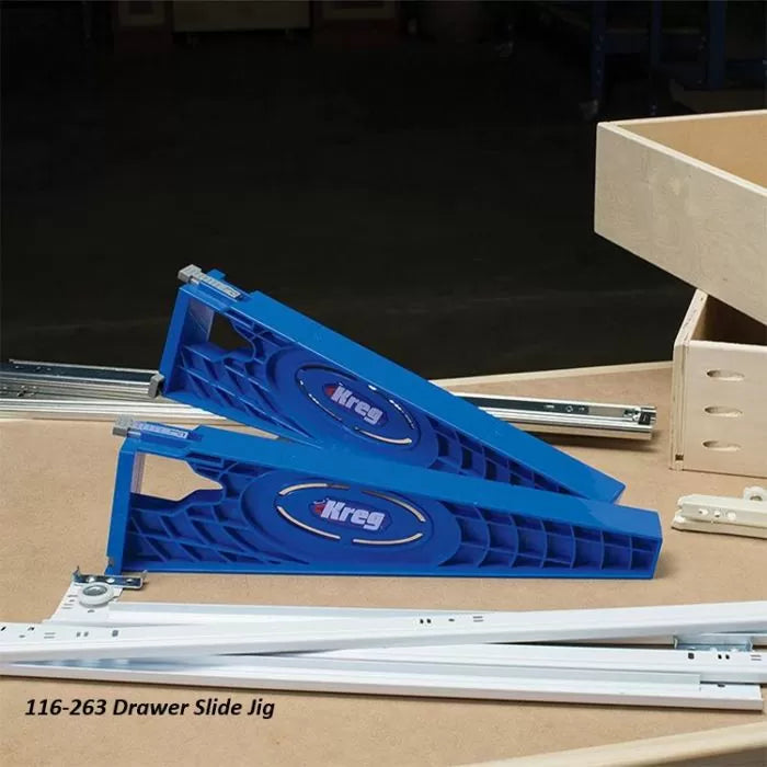 Kreg blue drawer slide jig set on woodworking table with metal drawer slides and wooden drawer box.