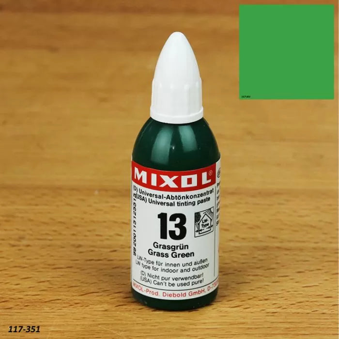 Mixol universal tinting paste bottle in grass green color on a wood surface