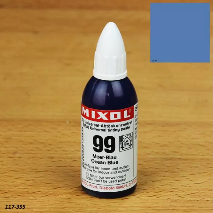 Mixol universal tinting paste 99 Ocean Blue bottle on wood surface with blue color swatch