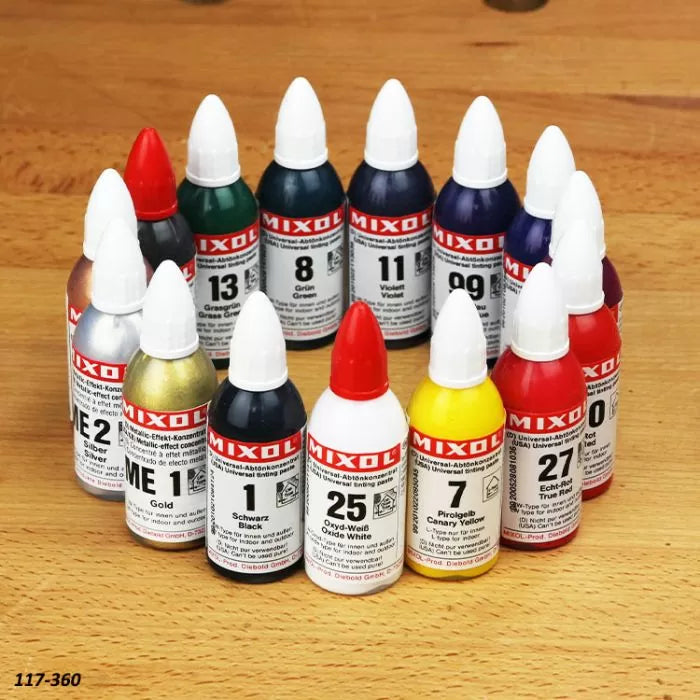 Assorted MIXOL universal color concentrate bottles arranged on a woodworking surface.