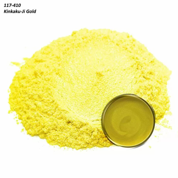 Bright gold metallic pigment powder with small round container on white background.