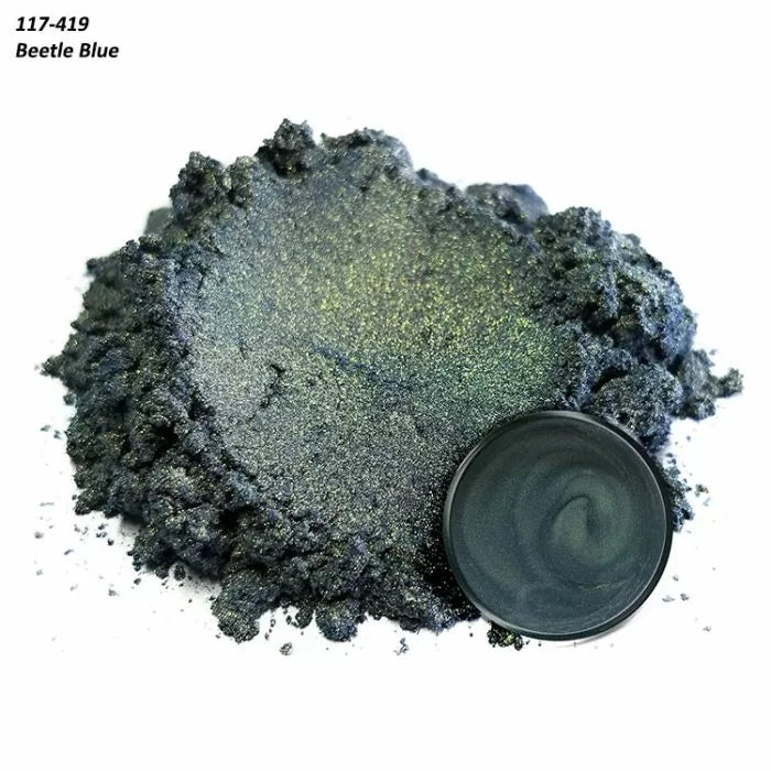 Beetle Blue metallic pigment powder with shimmer, shown loose and in a round container lid.