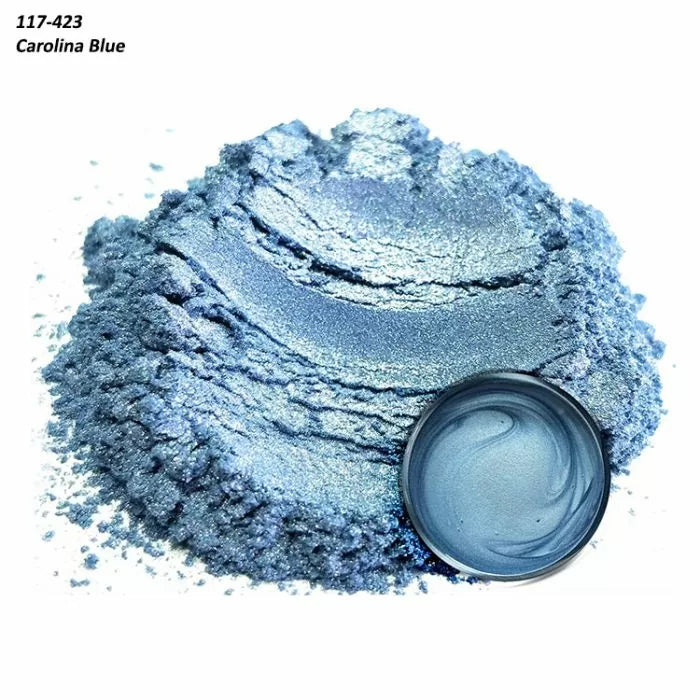 Shimmery Carolina Blue metallic pigment powder with a small round container on white background.
