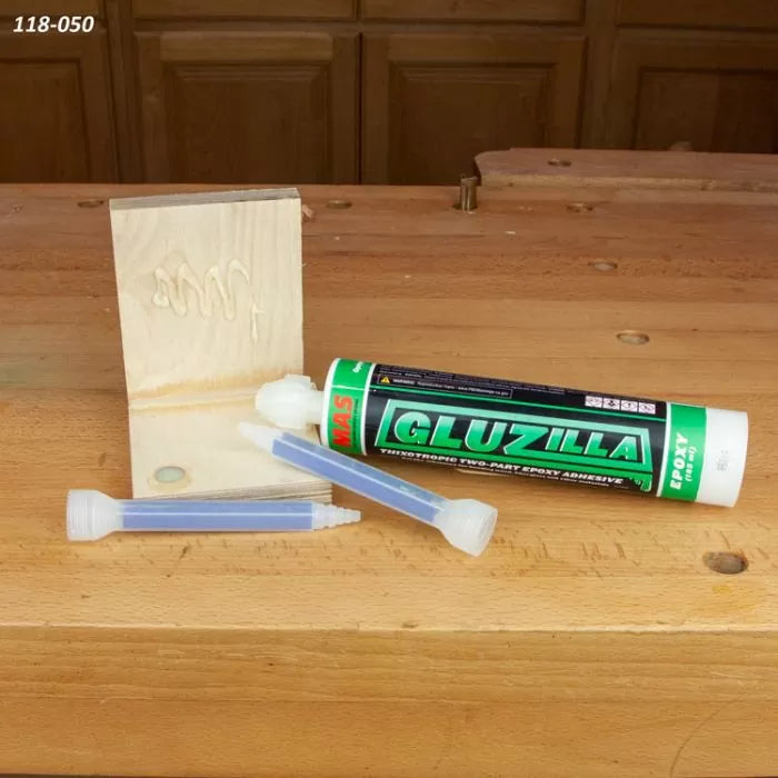 Two-part epoxy adhesive cartridge with mixing nozzles and wood joint on workbench