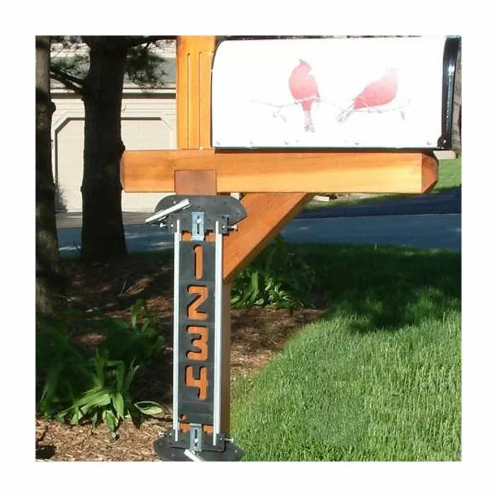 Wood mailbox post with metal address numbers and decorative cardinal mailbox design.